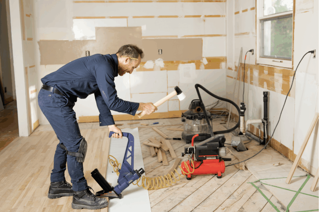 Blog header featuring installer nailing down hardwood floor